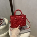 Red embossed leather handbag with chic floral pattern and gold hardware for women - Red