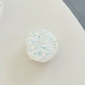 Detalle de soporte para móvil de resina en forma de concha con purpurina y brillo - Blanco