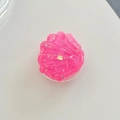 Detailed top view of pink resin shell phone socket with golden foil and scallop texture - Rose Red