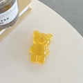 Detailed macro of bear-shaped phone grip with gold foil in transparent yellow resin - Yellow (Gold Foil Transparent Bear)