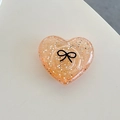 Dettaglio del supporto per telefono a cuore con glitter e motivo a fiocco nero - Cuore 3D Pois Glitter Fiocco Nero / Arancione