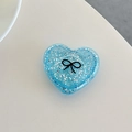 Macro shot of blue glitter heart phone grip featuring a black bow pattern and folding base - 3D Heart Polka Dot Glitter Black Bow / Blue