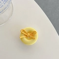 Close-up of yellow button phone grip holder with a matching fabric bow decoration - Yellow Bow Button