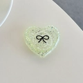Macro view of heart-shaped glitter phone grip with black bow pattern in mint green resin - 3D Heart Polka Dot Glitter Black Bow / Light Green