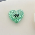 Detail of green glitter heart phone grip with a black bow print and sparkling sequins - 3D Heart Polka Dot Glitter Black Bow / Dark Green