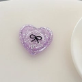 Macro shot of purple heart-shaped phone grip with silver glitter and black bow design - 3D Heart Polka Dot Glitter Black Bow / Purple