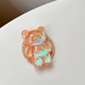 Detailansicht der orangefarbenen Laser-Bär Handyhalterung mit schimmerndem Glitzer-Effekt - Orange