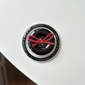 Macro shot of black button phone grip with red bow and Gift For You text detail - Magnetic Bow Button / Black