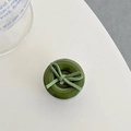 Detail view of a dark green phone socket with a matte finish ribbon bow design - Dark Green Bow Button