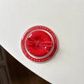 Close-up of a red magnetic phone grip with button shape and soft velvet bow detail - Magnetic Bow Button / Red