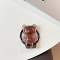 Detailed view of bear phone grip featuring brown resin with gold foil and Good Luck text - Brown