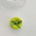Detail view of a green donut phone grip with a velvet bow ribbon on white background - Light Green Bow Button