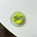 Detail of neon green button phone grip with suede bow and Gift For You print on base - Magnetic Bow Button / Fruit Green