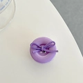 Close-up of a purple glossy button phone grip with a soft suede bow detail - Light Purple Bow Button