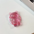 Close-up of pink transparent bear phone stand with gold foil flakes and Good Luck text - Pink