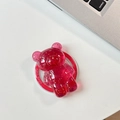 Macro view of a pink bear phone grip with gold flakes and a red Good Luck base - Deep Rose Red