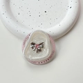 Detail shot of pearlescent resin phone grip with silver bow and pink heart gemstone - Irregular Ring White Flash - Pink Diamond Bow