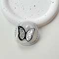 Makroaufnahme einer Schmetterling-Handyhalterung mit Perle auf Keramikteller, Gift For You - Irregulärer Ring Weißer Blitz - Schwarze Linie Schmetterling