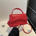 Vibrant red handheld crossbody bag with minimalist flap design and gold hardware - Red