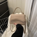 Chic beige matte leather handbag with curved flap and adjustable strap for women - Khaki