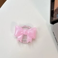 Dettaglio dell'impugnatura per telefono a fiocco rosa glitterato su una scrivania - Fiocco Grande Magnetico - Perlato / Rosa