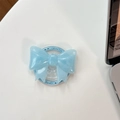 Detail of glitter light blue bow phone grip with Gift For You print on white desk - Magnetic Large Bow - Pearlescent / Blue
