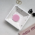 Detail shot of white terrazzo style tray and pink round phone stand on lifestyle background - Pink
