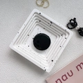 Macro detail of a nordic white speckled square tray with a black circular phone grip - Black