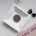 Detail view of a square tiered jewelry tray with black splattered ink pattern and round slot - Coffee Grey