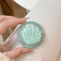 Detail of mint green shell MagSafe phone grip with Gift For You print and glitter finish - Glitter Jelly Seashell / Light Green