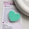 Détail du support de téléphone cœur vert menthe avec finition brillante sur fond blanc - Vert Lait