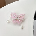Dettaglio del supporto per telefono in pizzo rosa con fiocco di perle e nappine - Ricamato / Rosa