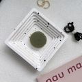 Olive green collapsible phone socket on a white marble splatter tray for desktop support - Dark Green