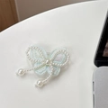 Detailed view of a light blue lace butterfly phone socket with elegant pearl bead charms - Embroidered / Light Green