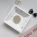 Detail view of square marble textured tray with a round beige pop socket phone stand - Milky Grey