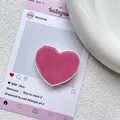 Vue macro du support de téléphone en forme de cœur rose pêche avec une finition brillante - Rose foncé