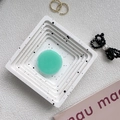 Macro view of translucent emerald green resin phone grip on a white minimalist tray - Milky Green