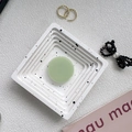 Flat lay of a light green round phone socket holder on a marble textured tray - Light Grass Green