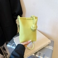 Minimalist lime green pebbled leather mini crossbody bag with stylish knot details - Green