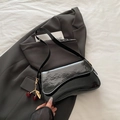 Glossy black patent leather shoulder bag with cherry charm and wavy flap design - Black with Pendant