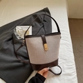 Vintage beige woven canvas bucket bag with brown leather trim and golden metal clasp - Brown