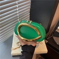 Green oval leather handbag with golden sculptural handle and sleek snake chain strap - Green