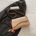 Minimalist beige patent leather underarm bag with irregular flap on a grey blazer - Khaki (No Pendant)