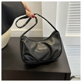 Close-up of black crescent underarm bag with polished PU leather and fashion plaque - Black
