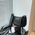 Chic black litchi pattern baguette bag with gold bow hardware for minimal summer outfits - Black
