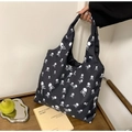 Minimalist black tote bag with white skull print and integrated handle for daily shopping - Skull
