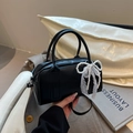 Chic black leather Boston handbag with elegant pearl and white lace bow accessory - Black with Pendant