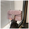 Detailed close-up of pink marble pattern faux leather with sparkling diamond buckle lock - Purple