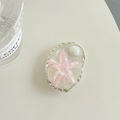Dettaglio macro del supporto cellulare a stella marina rosa con bordo argento - Rosa