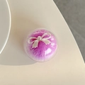 Detail of round purple faux fur phone grip with a white pearl-finish ribbon bow decoration - Purple